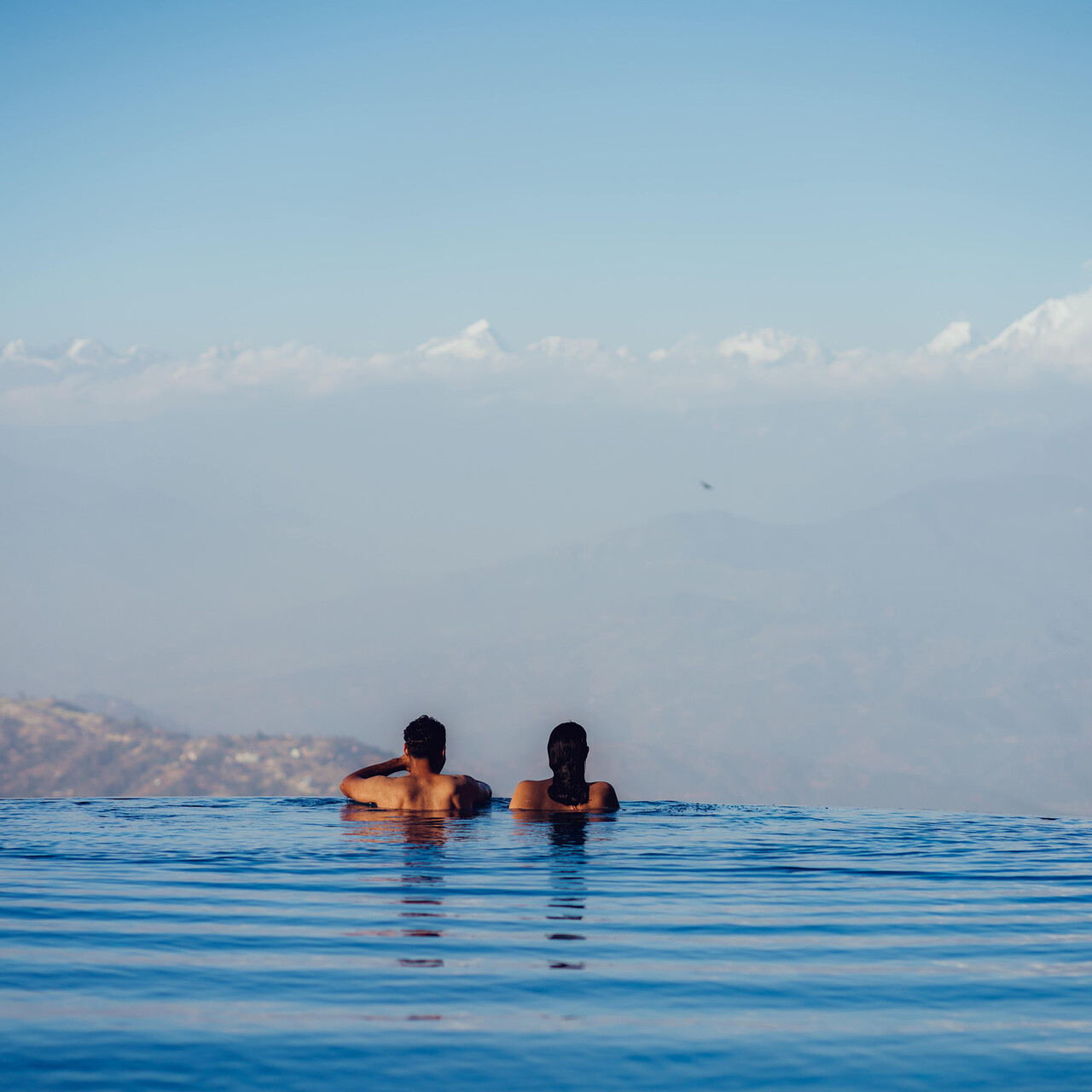 Ananta Infinity Pool suspended above the valley with Himalayan mountain views