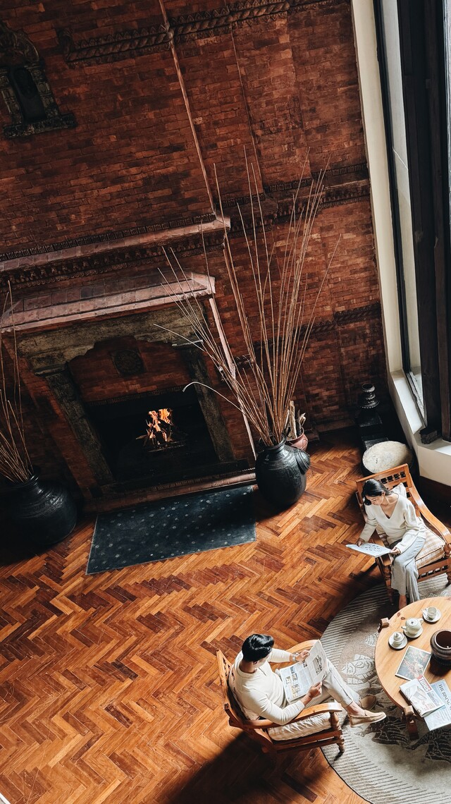 The Lobby Fireplace surrounded by antique sculptures and masks.
