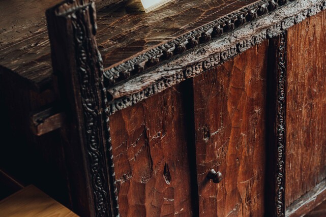 Each room holds pieces the family chose &mdash; antique furniture drawn from Newari and Himalayan tradition that make the space feel inherited.