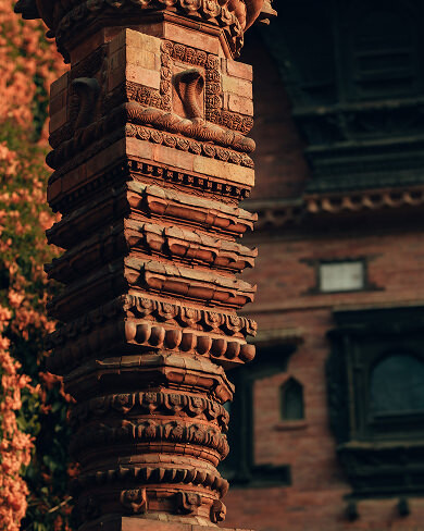 Intricately carved terracotta pillar with traditional Newari patterns